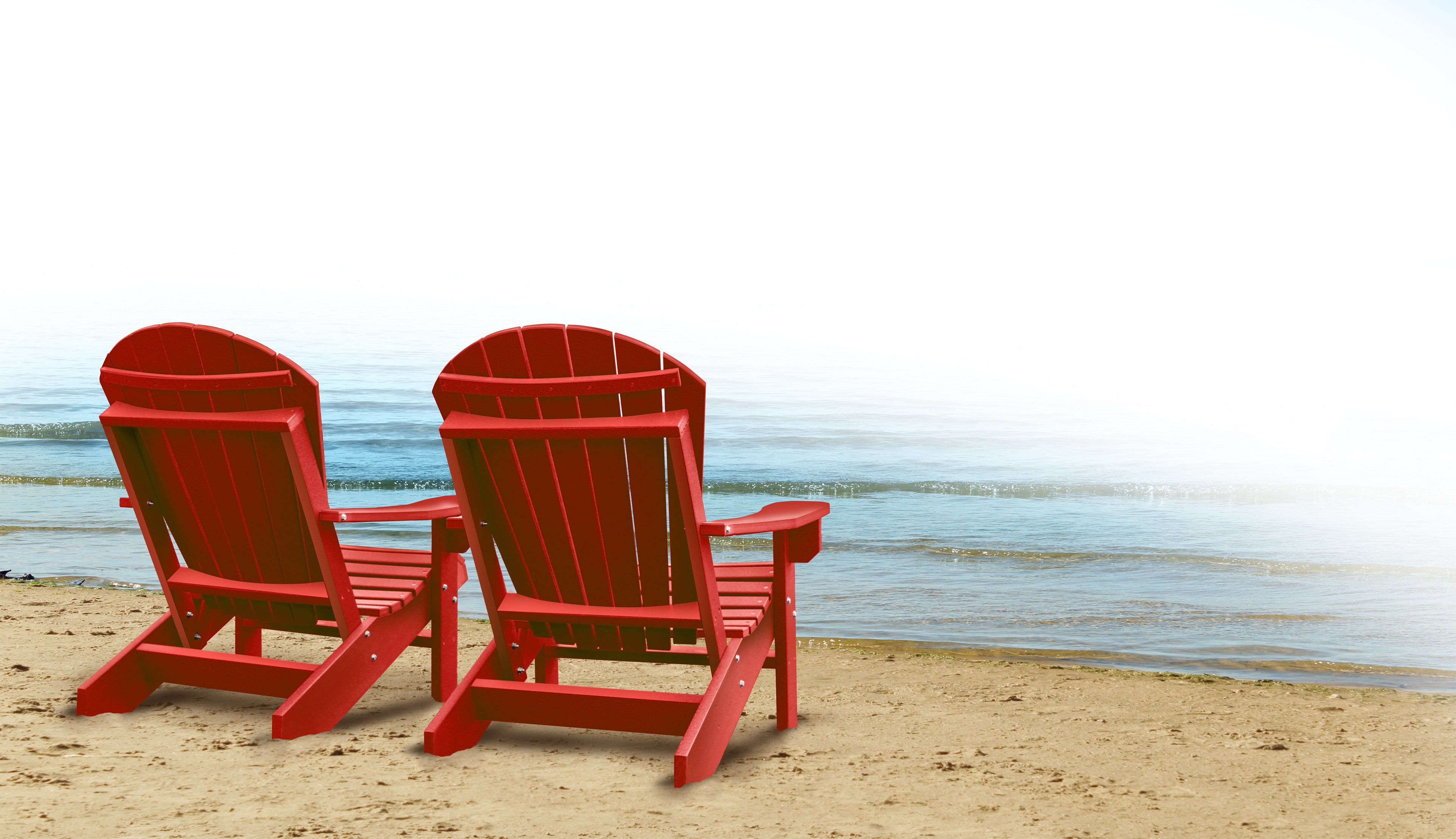 Two red wooden beach chairs sitting on the sand