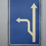 Blue road sign that has a detour route arrow