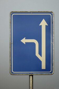 Blue road sign that has a detour route arrow