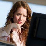 Woman concentrating sitting at computer