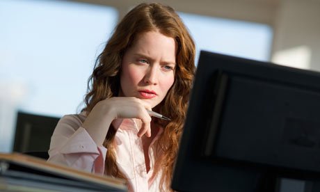 Woman concentrating sitting at computer