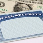 A blank social security card sits atop a $1 bill
