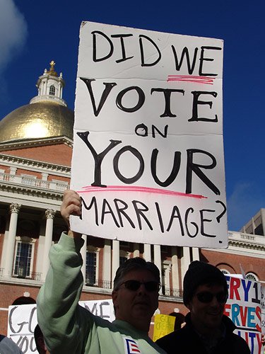 Man holds sign reading Did We Vote on Your Marriage? at gay marriage protest