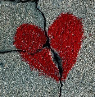 Chalk heart drawn over a crack in the sidewalk