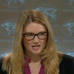 Marie Harf wearing glasses and caught mid sentence