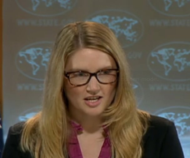 Marie Harf wearing glasses and caught mid sentence
