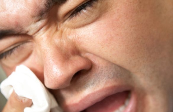 Man cries dramatically while holding tissue to eye