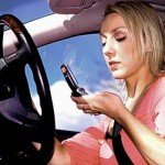 Woman stares at cellphone while she's driving