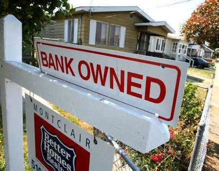 Sign on house that reads Bank Owned