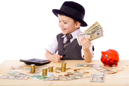 Kid playing at table with varying types of money and a calculator