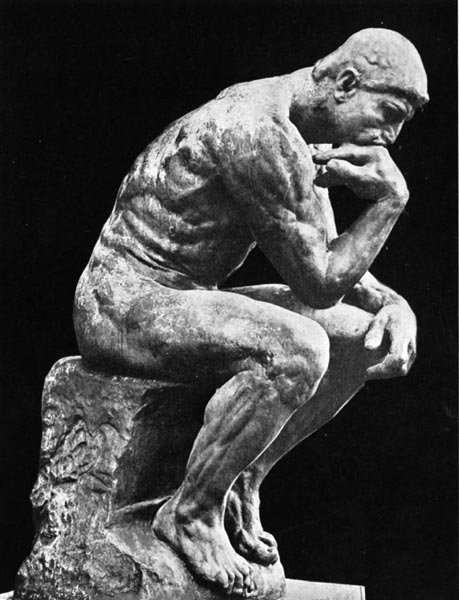 Stone statue of The Thinker with black background
