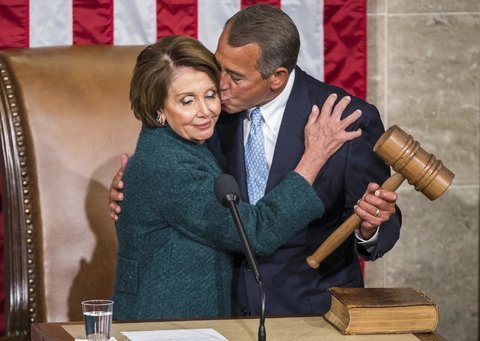 Boehner hugs and kisses Pelosi on the cheek while holding gavel