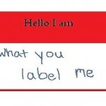 Red and white nametag reads Hello I am what you label me