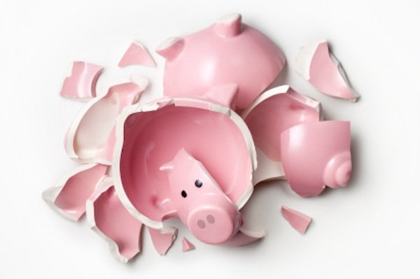 Pink piggy bank smashed into several pieces