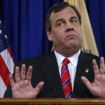 Chris Christie holds hands up at speaking event