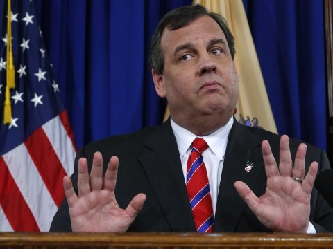Chris Christie holds hands up at speaking event