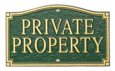 Green and gold sign that reads Private Property