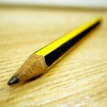 Closeup of a pencil point on a wooden table