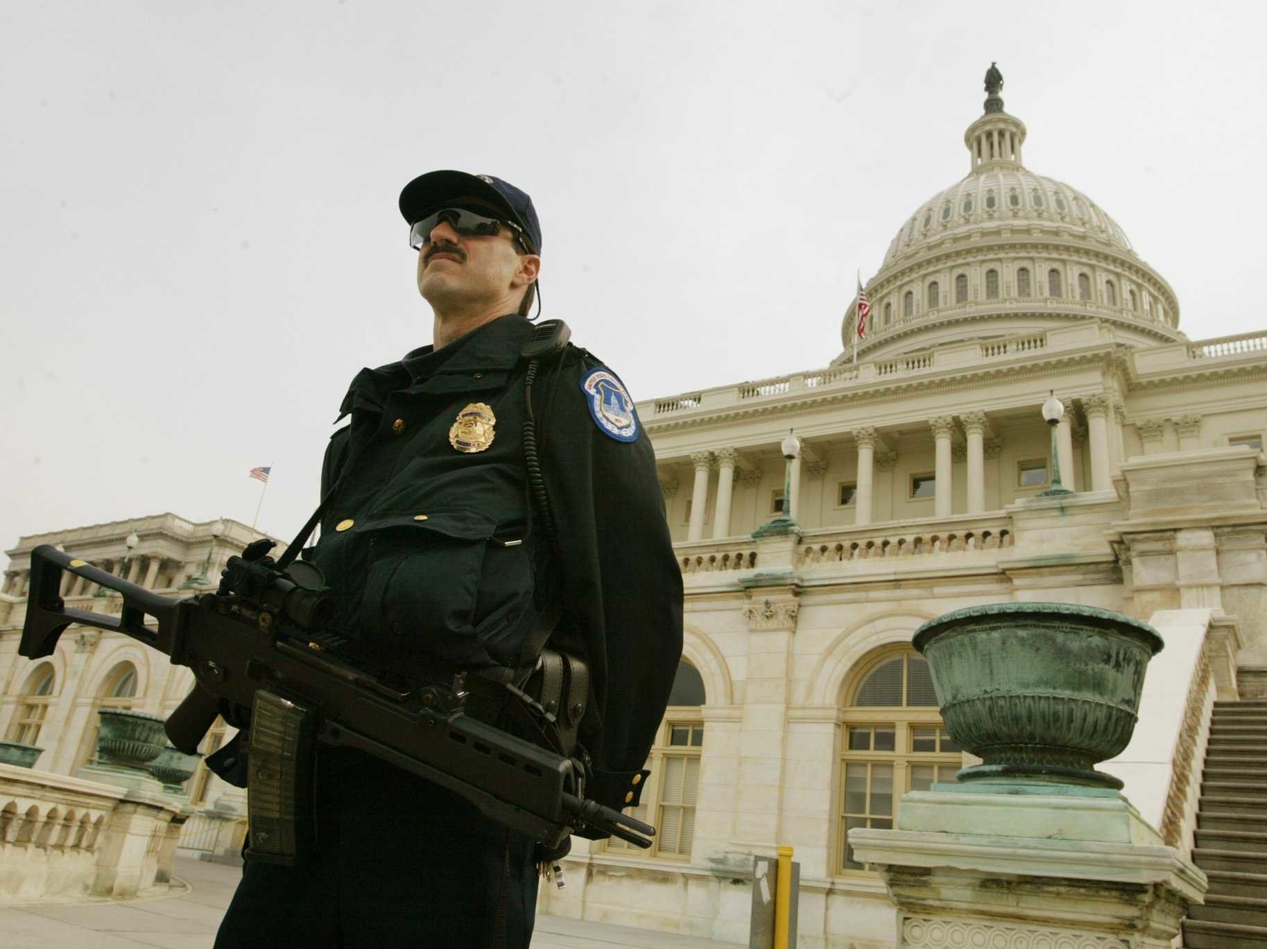 Homeland Security officer stands guard with rifle