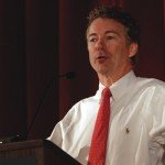 Rand Paul giving speech wearing white shirt with red dotted tie