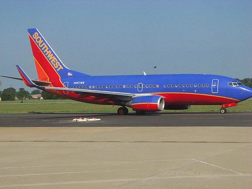 Southwest Airlines red and blue airplane sitting at airport runway