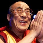 Closeup of the Dalai Lama as he smiles and greets