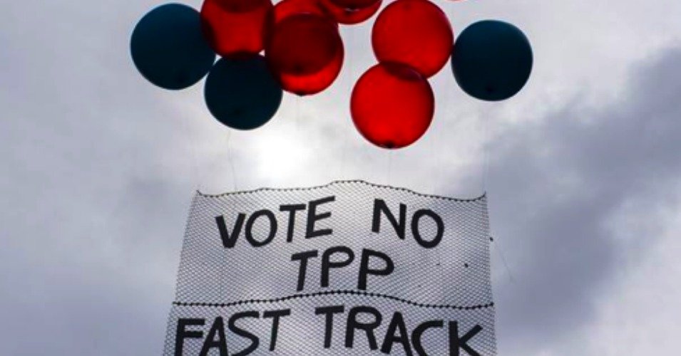 Red and black balloons on sign that reads Vote No TPP Fast Track
