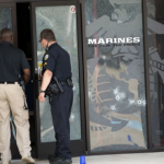 Cops investigate the door frame of the Marines office in Chattanooga