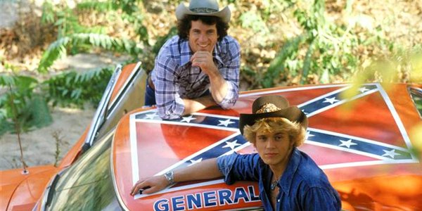 Actors pose with car with confederate flag on roof