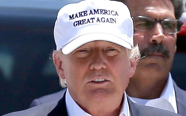 Donald Trump wearing a white hat reads Make America Great Again
