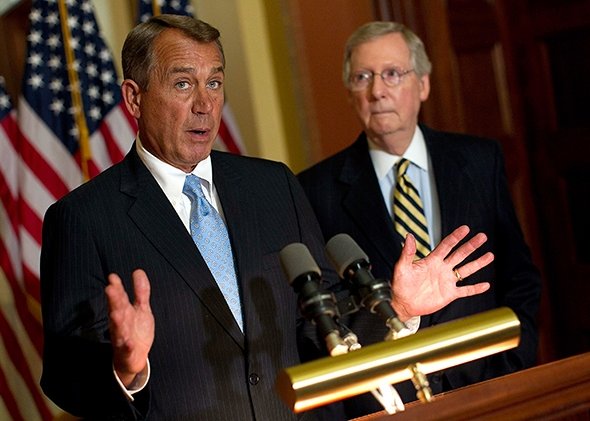 John Boehner speaks with Mitch McConnell in background
