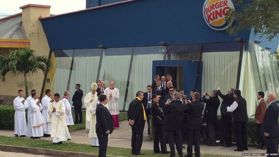 The Pope visits Burger King while onlookers watch