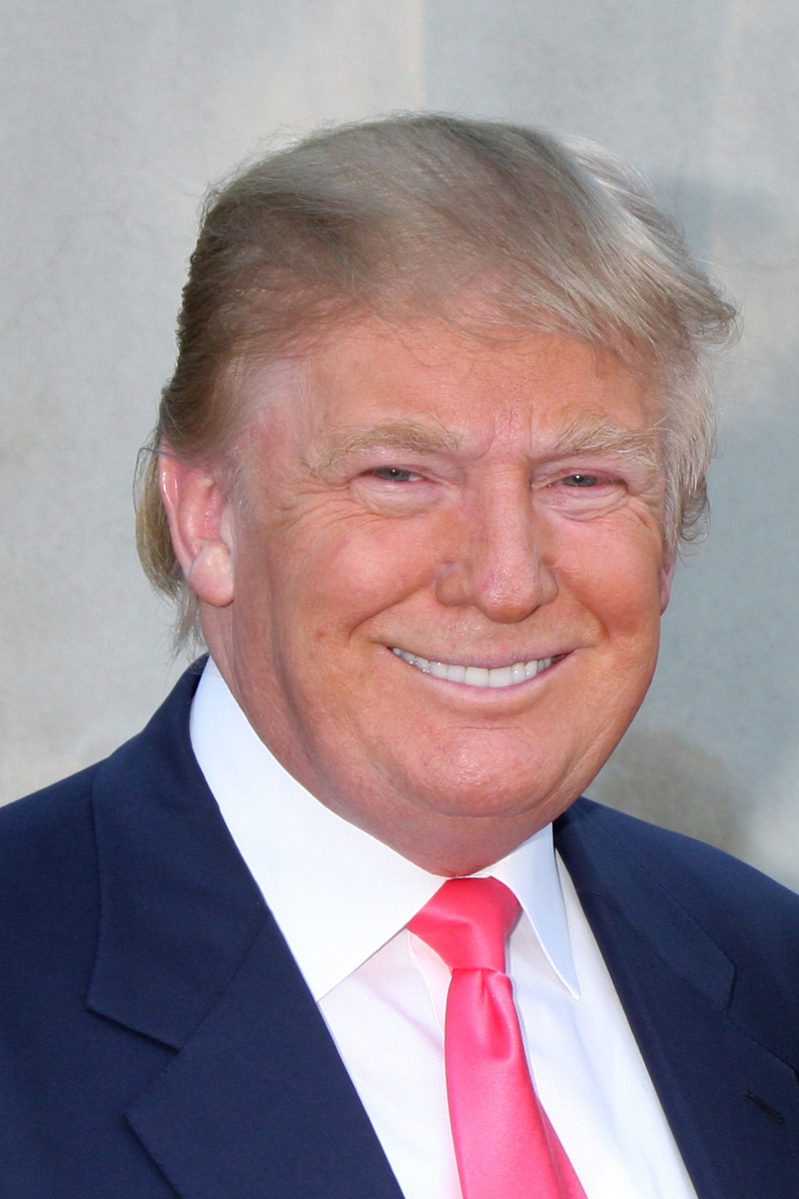 Donald Trump smiling wearing suit and tie