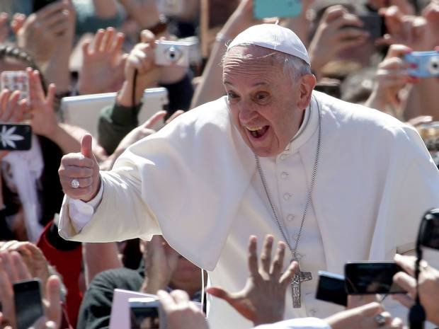 Pope Francis poses for pictures with thumbs up