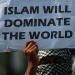 Woman holds sign reading Islam will dominate the world