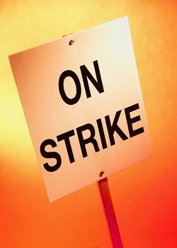 Picket sign reads On Strike